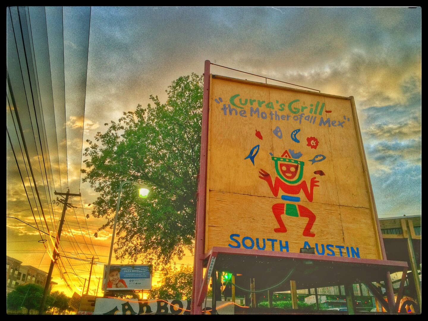 A sign that says south austin at sunset.