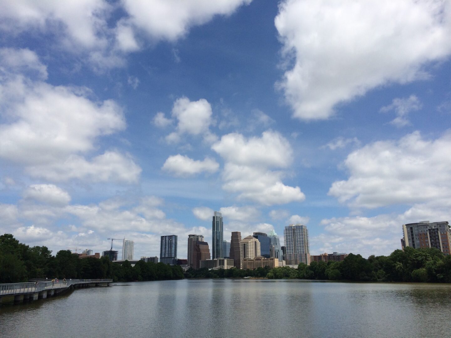A lake with a city skyline in the background.