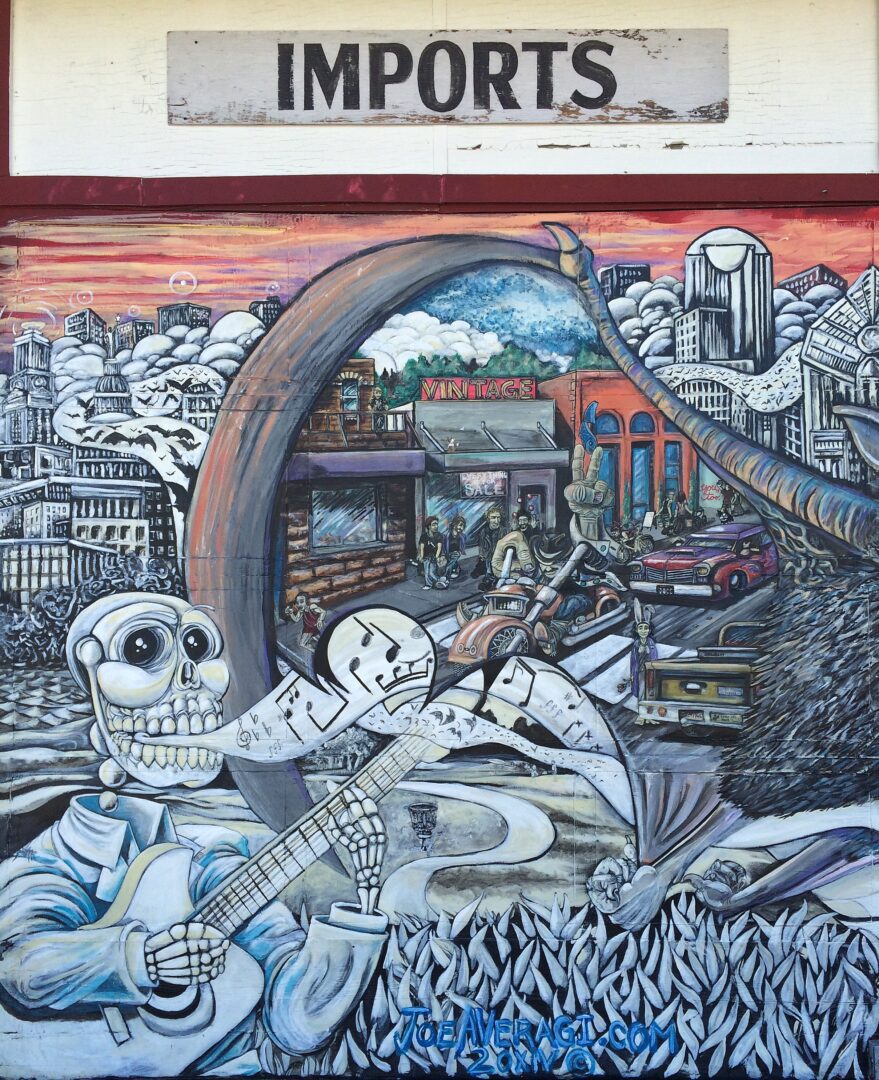A mural of a skeleton and a guitar on a building.