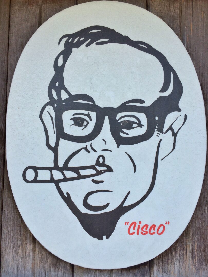 A sign with a man in glasses smoking a cigarette.