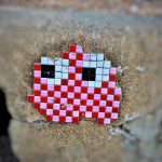 A red and white checkered pixel art on a wall.