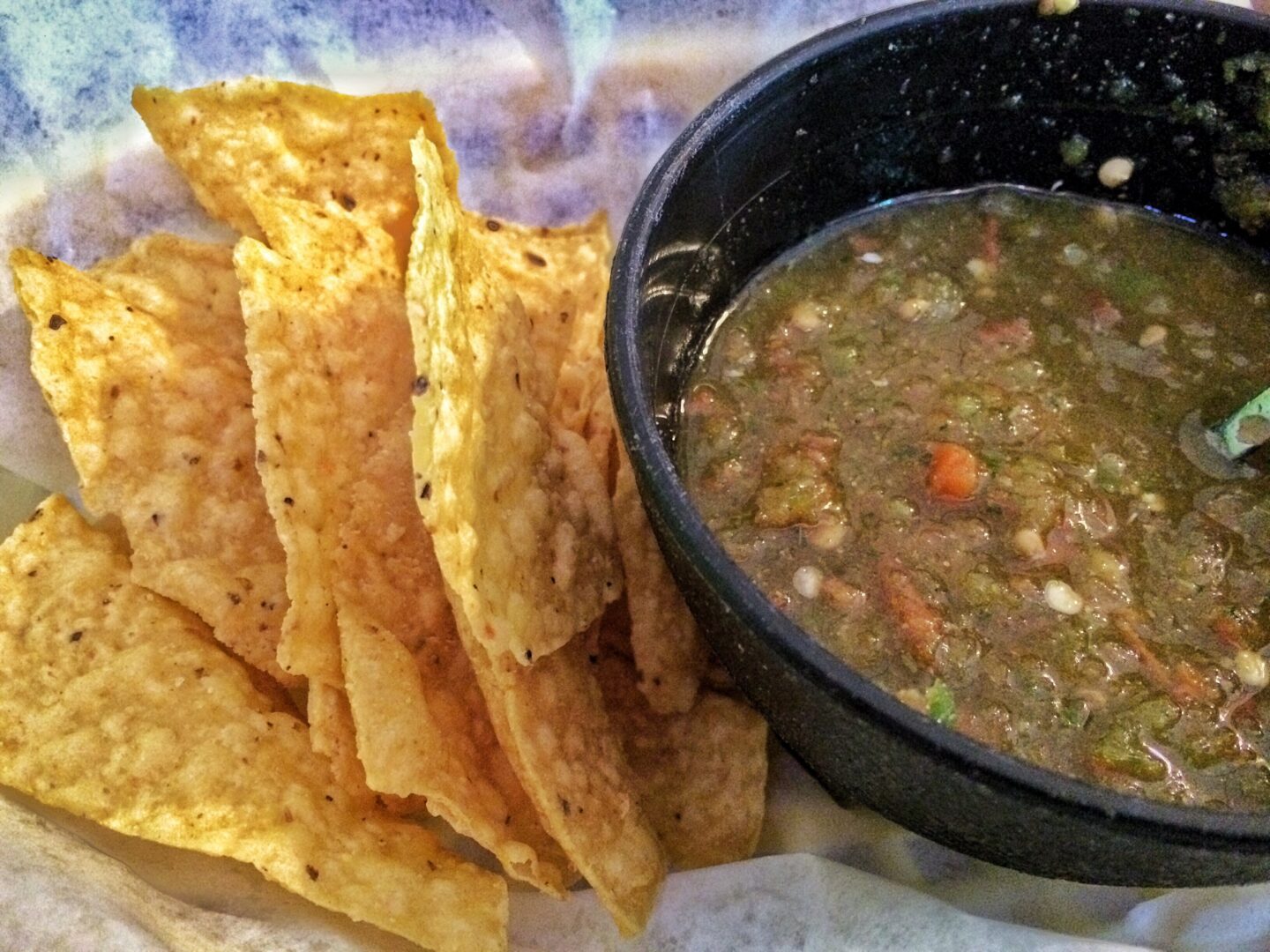 Guacamole and tortilla chips in a bowl.