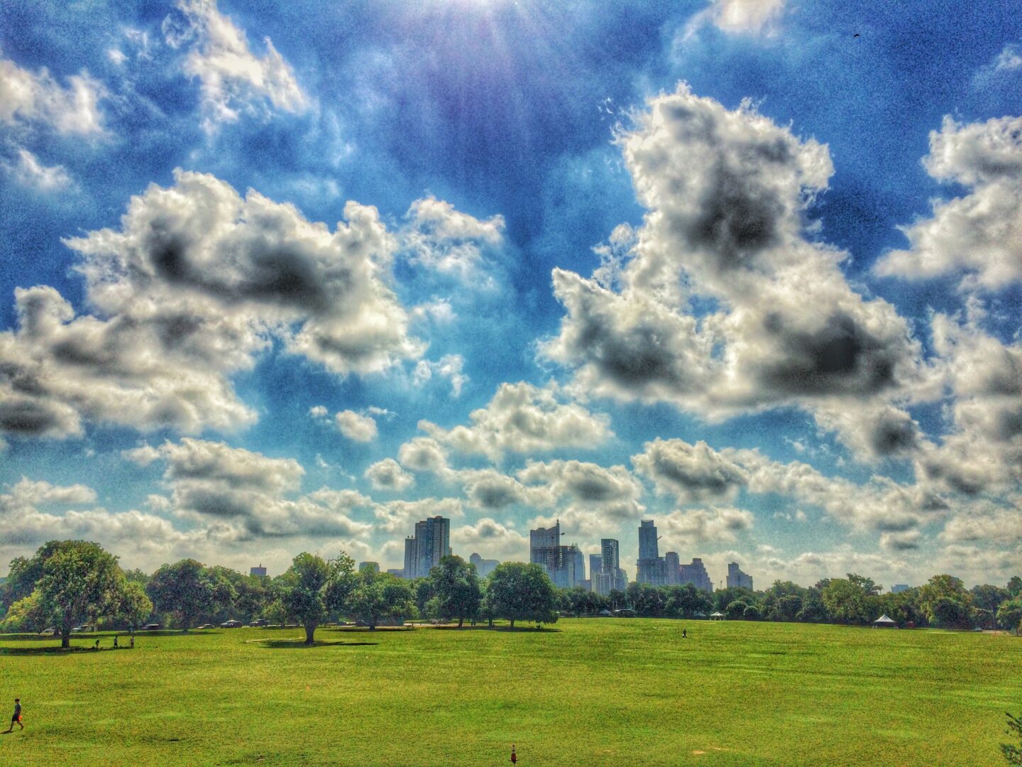 A cloudy sky with a city in the background.