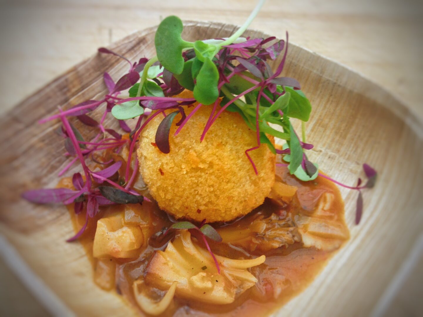 A plate of food on a wooden table.