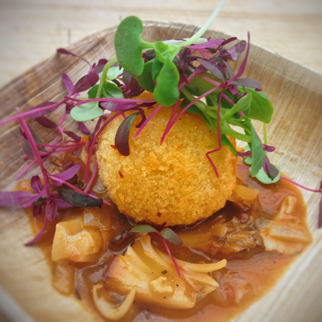 A plate of food on a wooden table.