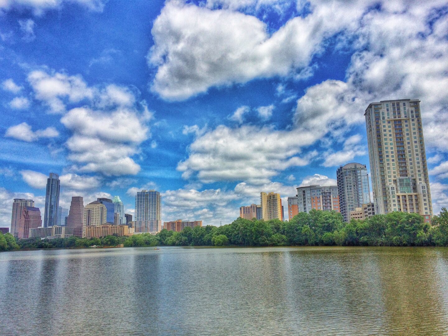 A lake with a city skyline in the background.