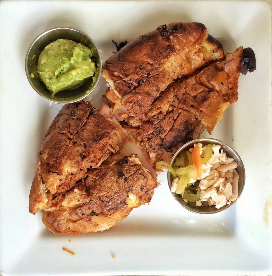 A plate of food with guacamole and a side of guacamole.