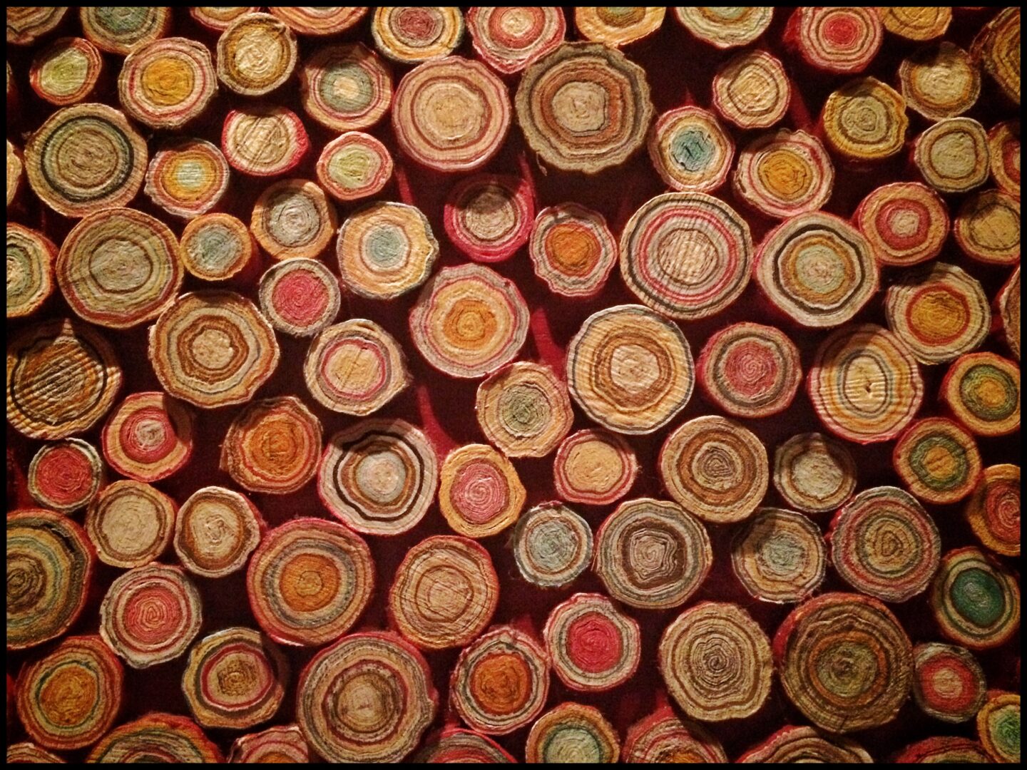 A wall of woven baskets on a red background.