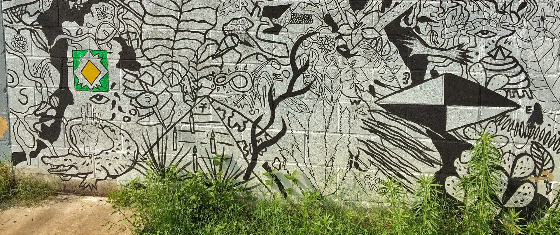 A black and white mural on the side of a building.