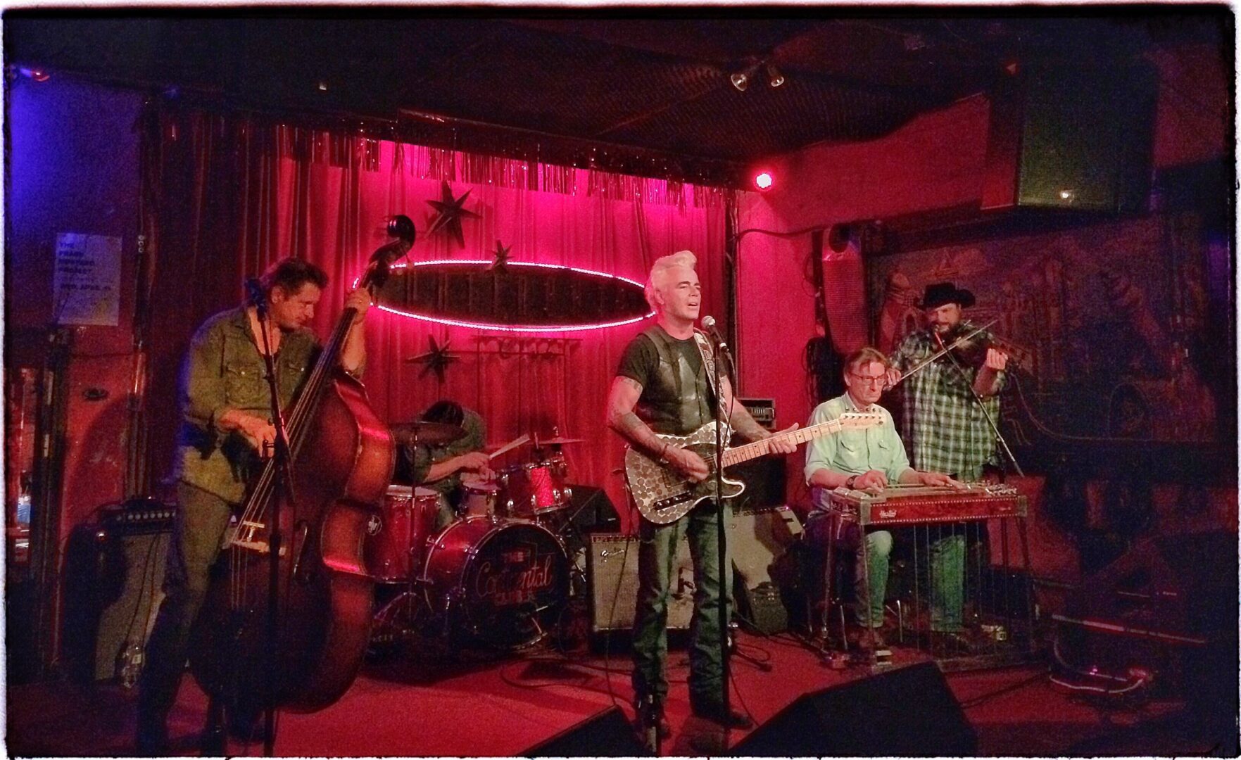 A group of musicians playing music in a bar.