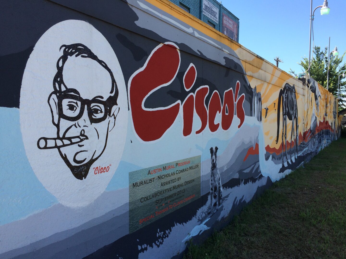 A mural of a man smoking a cigarette on the side of a building.