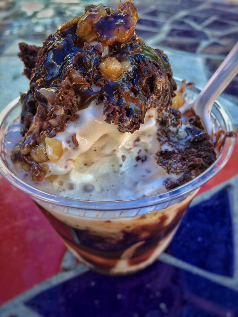 A cup of ice cream with a spoon in it.