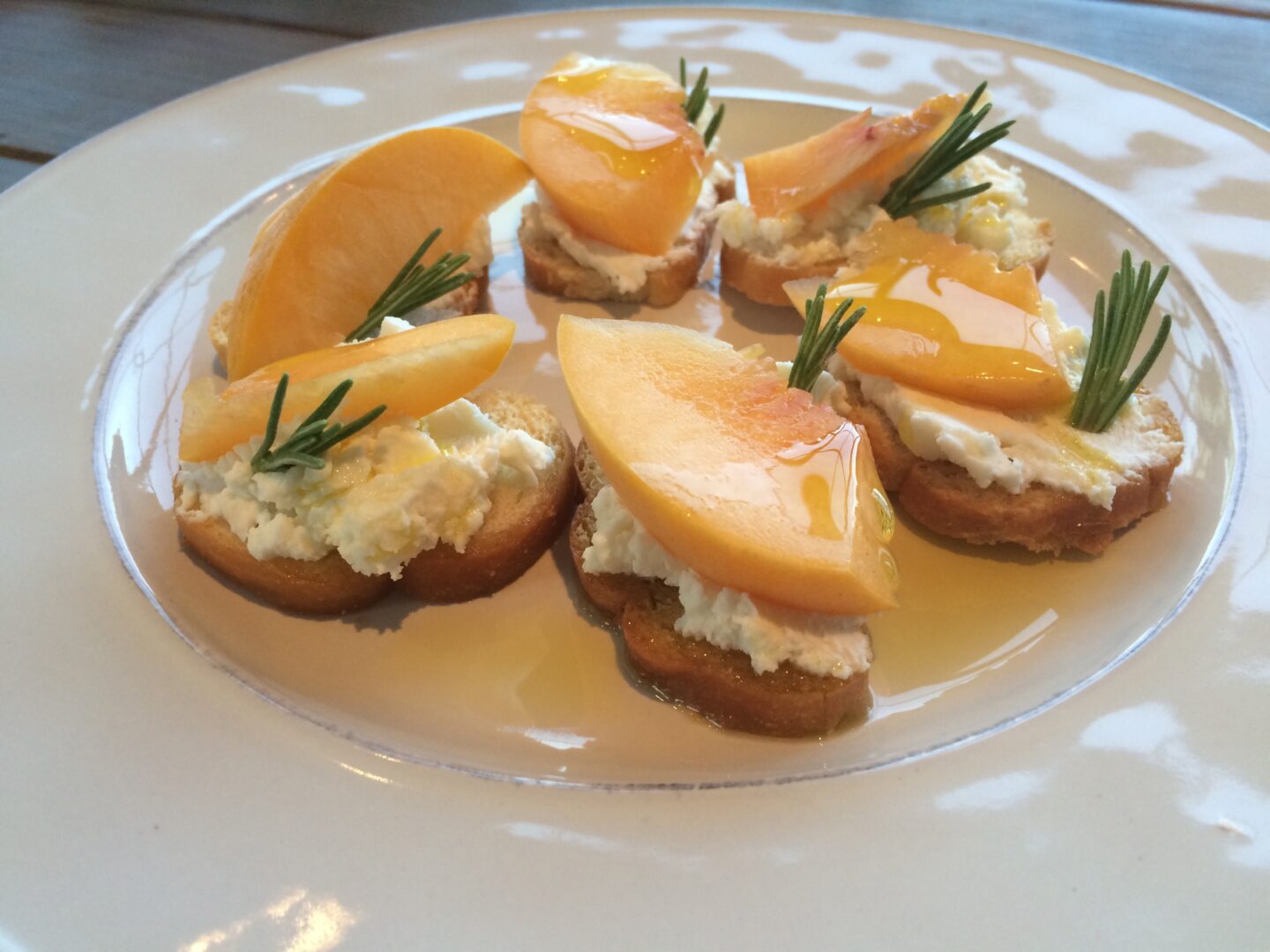 Peach crostini with goat cheese and rosemary.