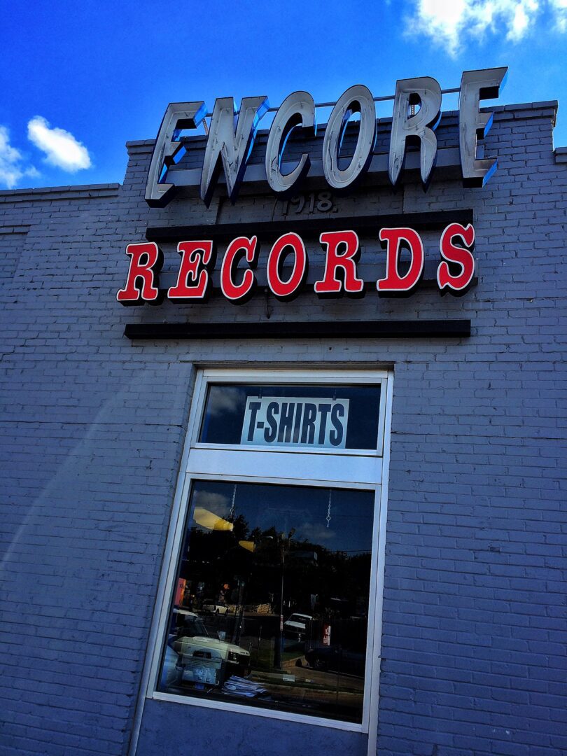 A brick building with a sign that says encore records.