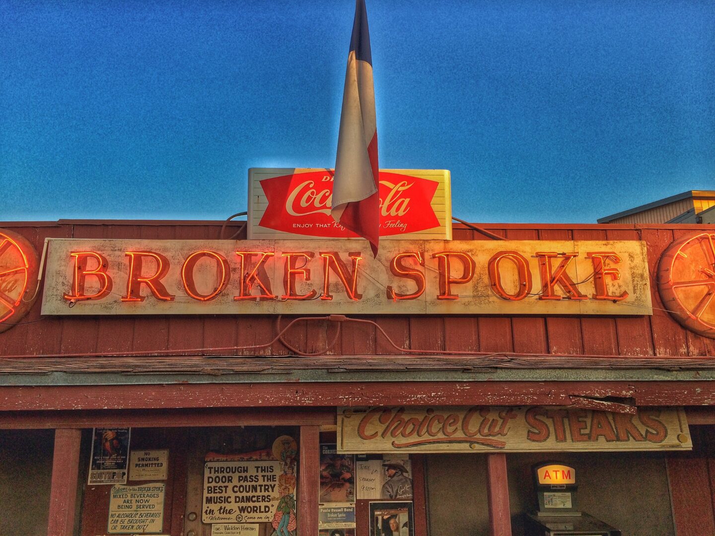 A red building with a broken spoon sign.