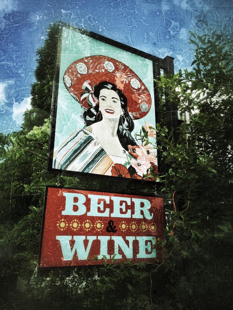 A beer and wine sign with a woman in a hat.