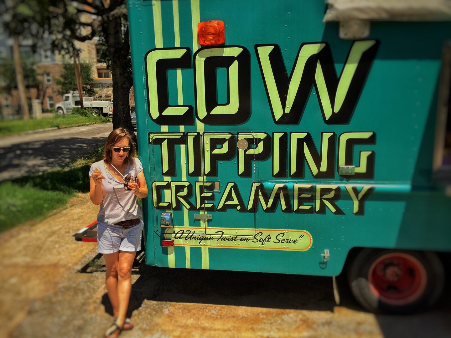 A woman standing in front of a food truck.