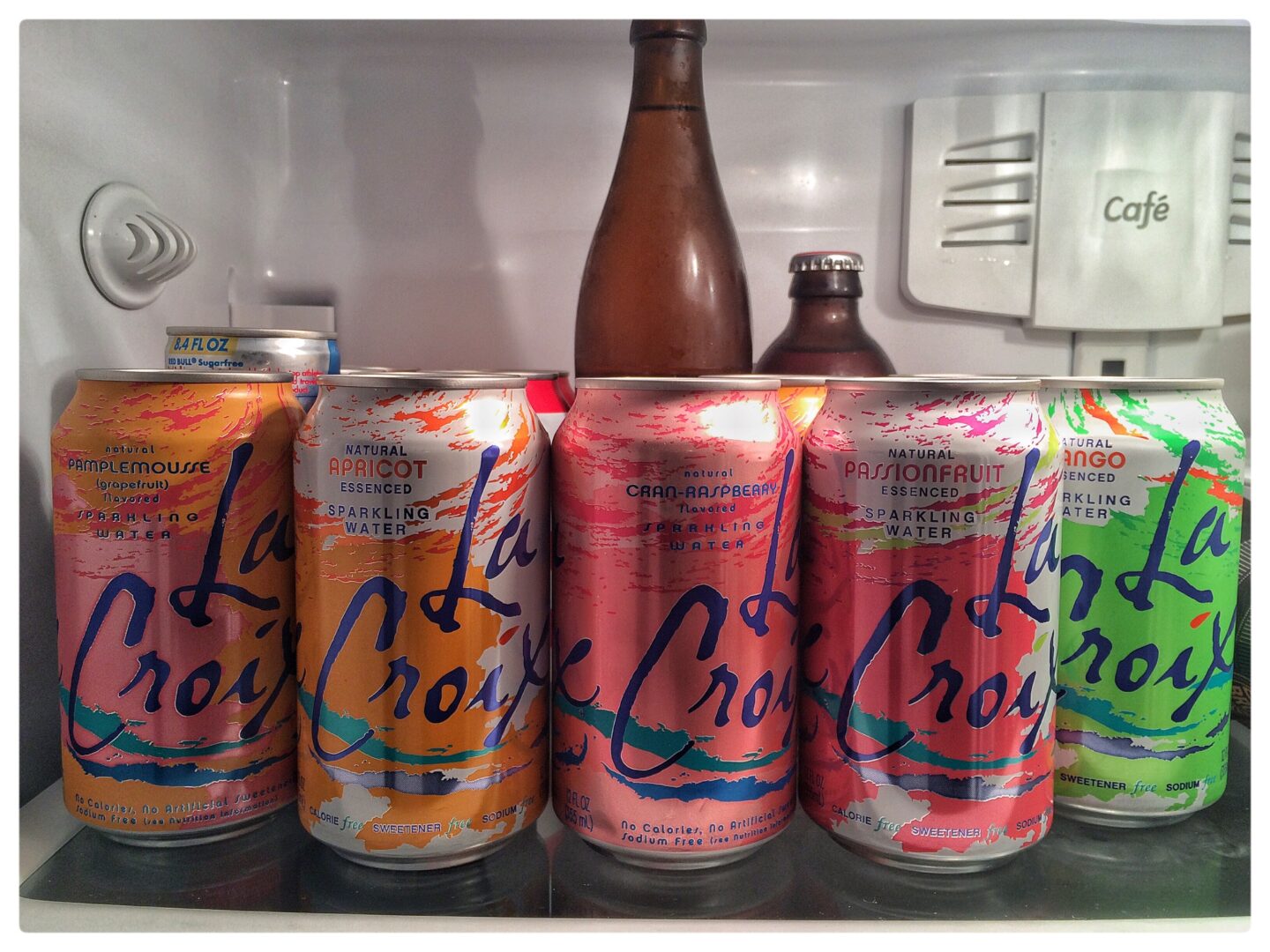 A refrigerator full of cans of soda.