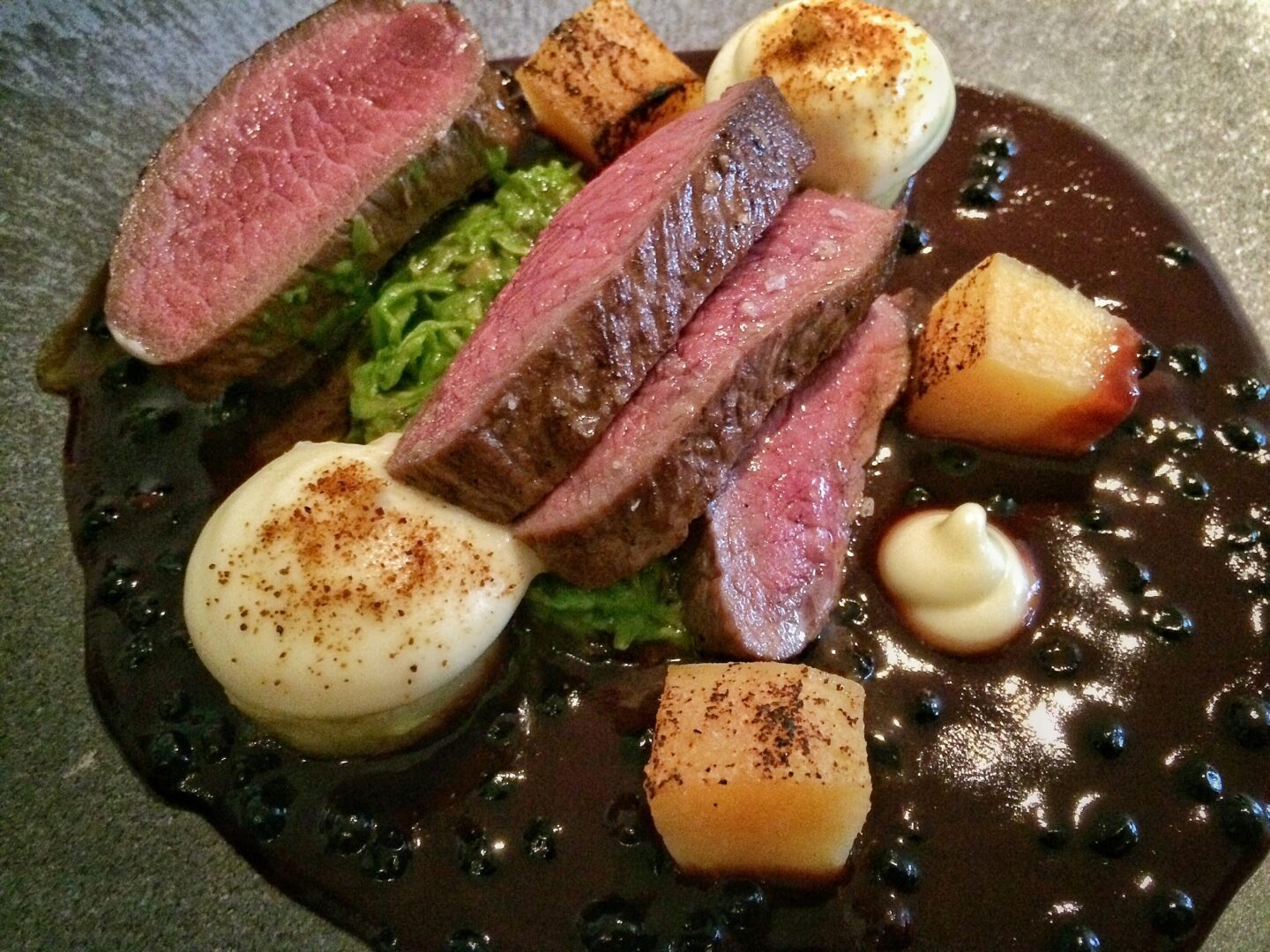 A plate with a steak and vegetables on it.