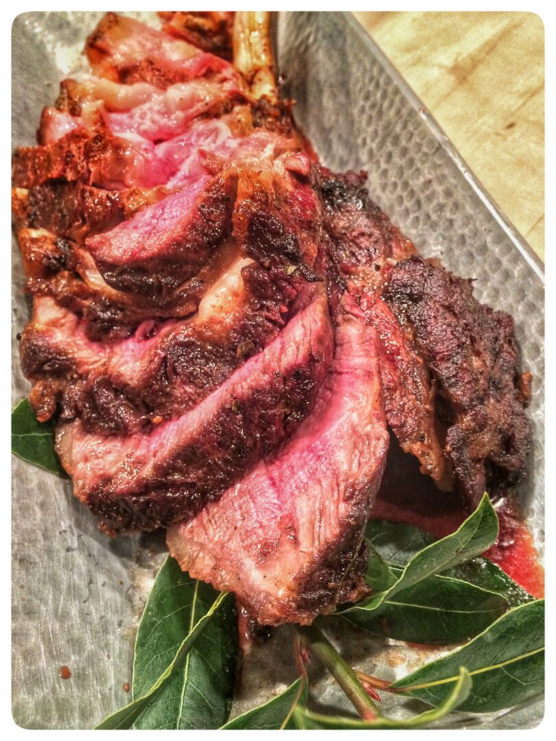 A Perfectly Medium Rare Steak is Presented on its Platter for the Table