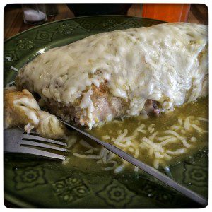 Mexican enchiladas with cheese on a plate.