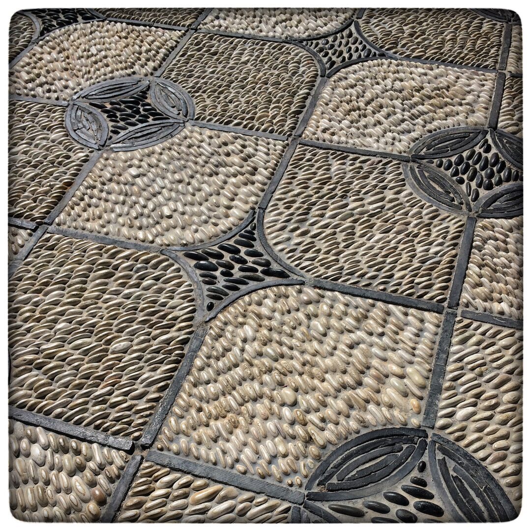 A close up of a tiled floor with a pattern.