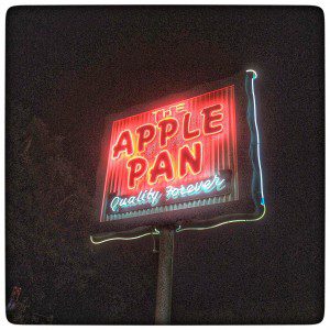 A neon sign for the apple pan.