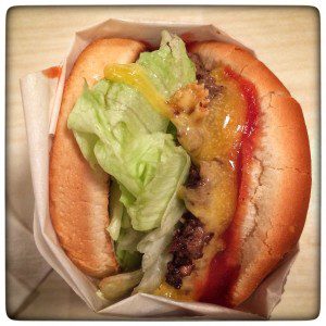 A burger with lettuce and cheese.