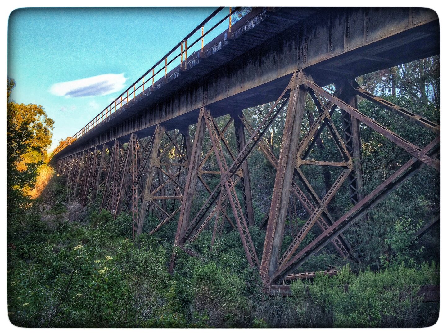 A train bridge over a river.