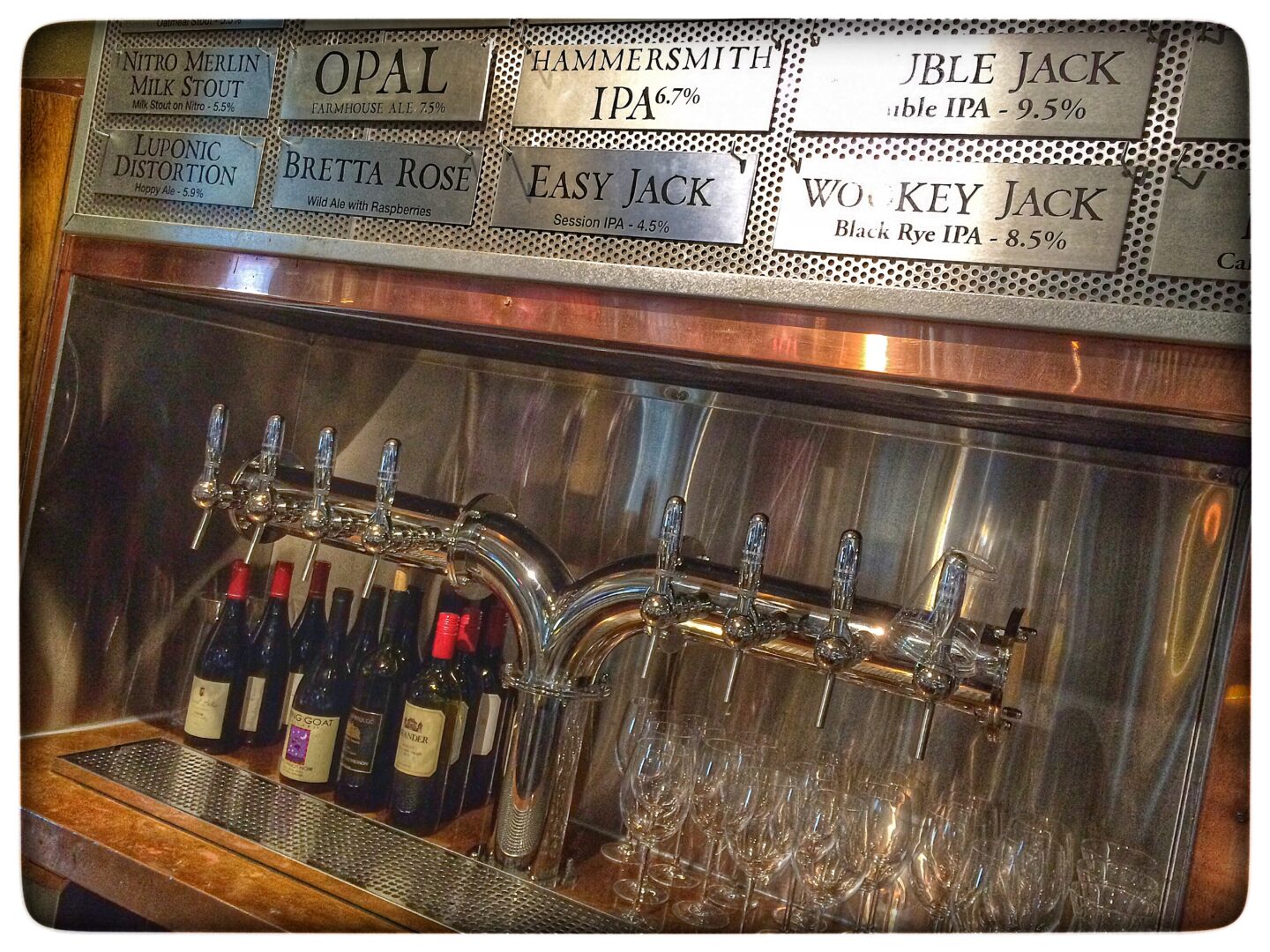 A bar with a lot of bottles of wine.