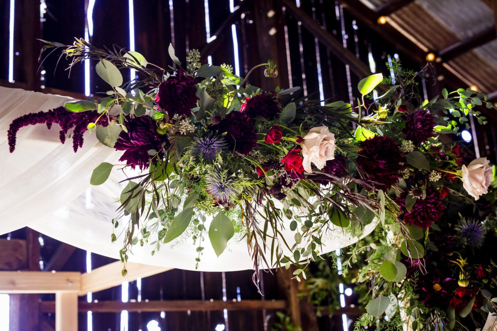 A wedding arch decorated with flowers and greenery.