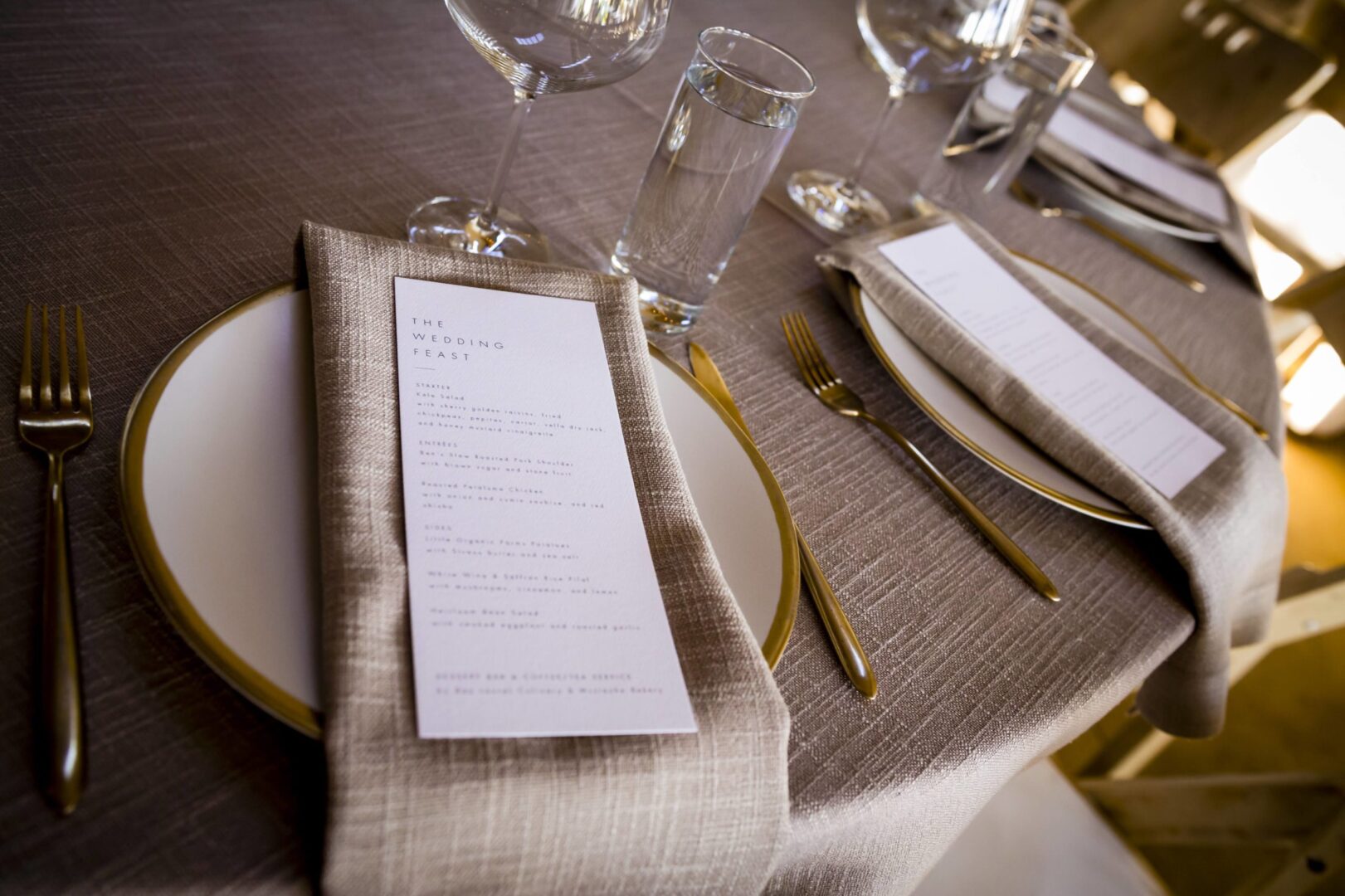 A table setting with a menu and silverware.