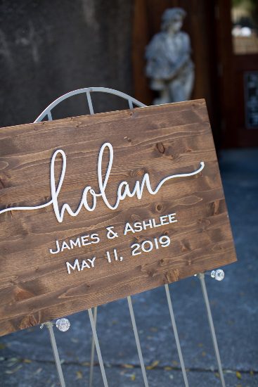 A wooden sign with the words holan james and ashley.