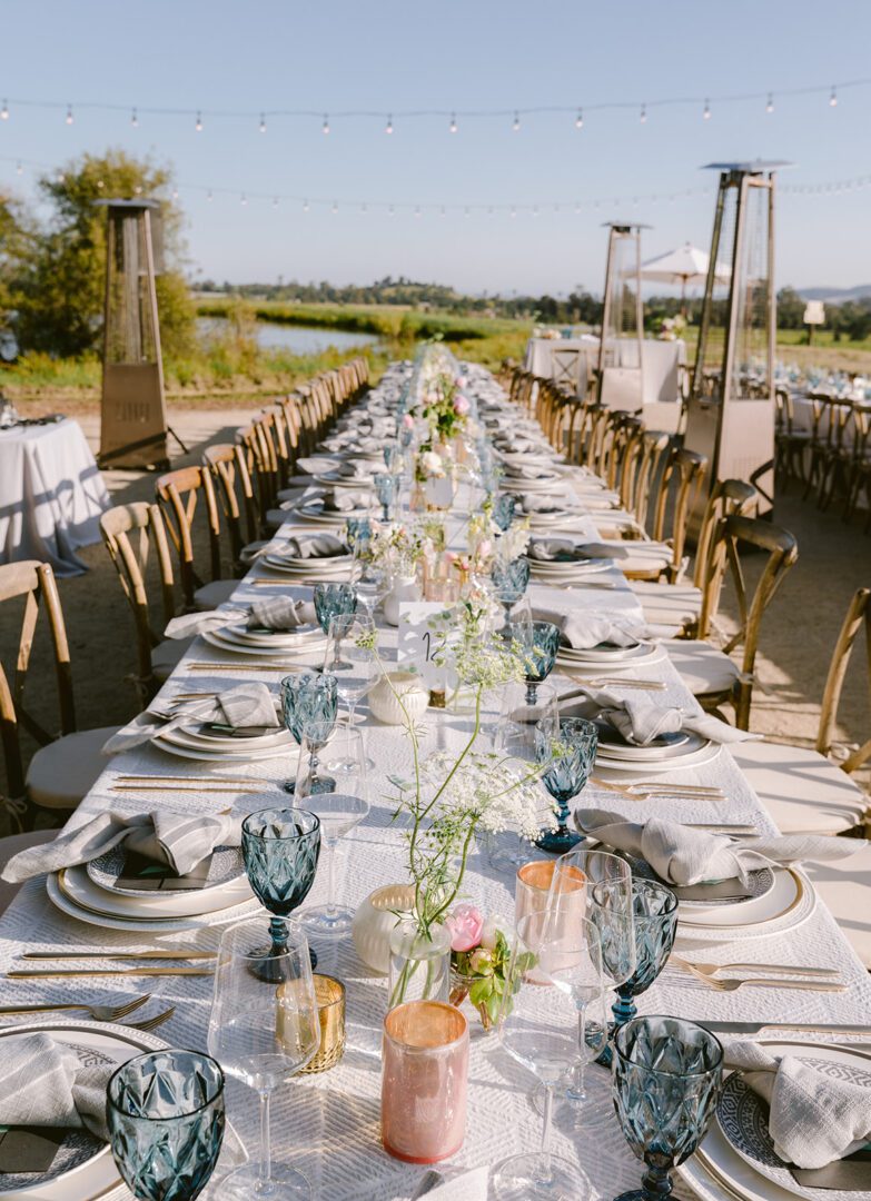 A long table set up for a wedding reception.