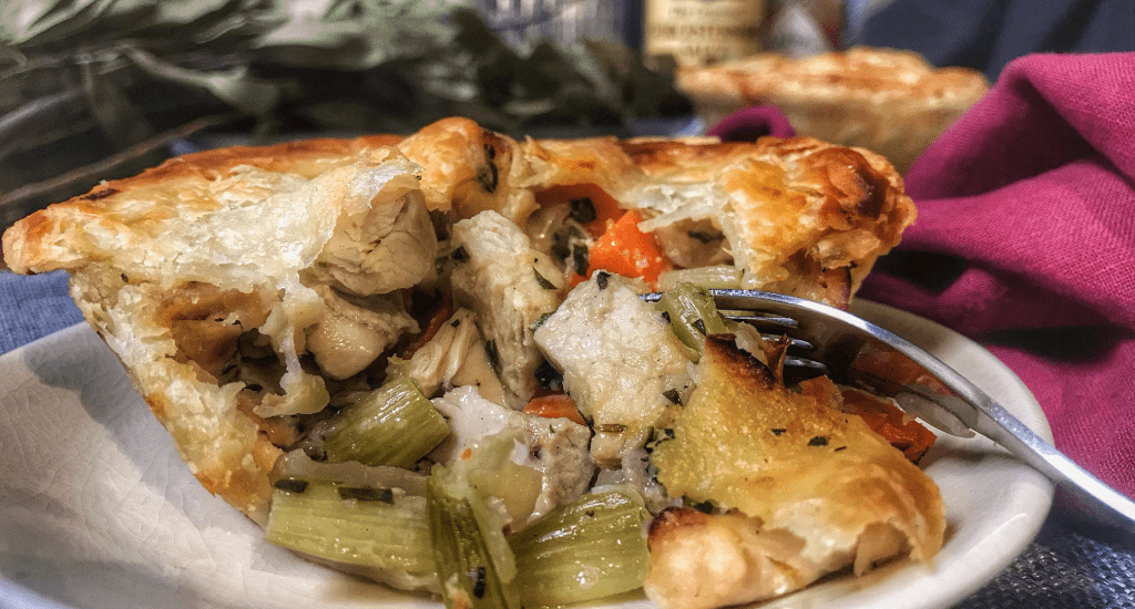 Chicken pot pie on a plate with a fork.