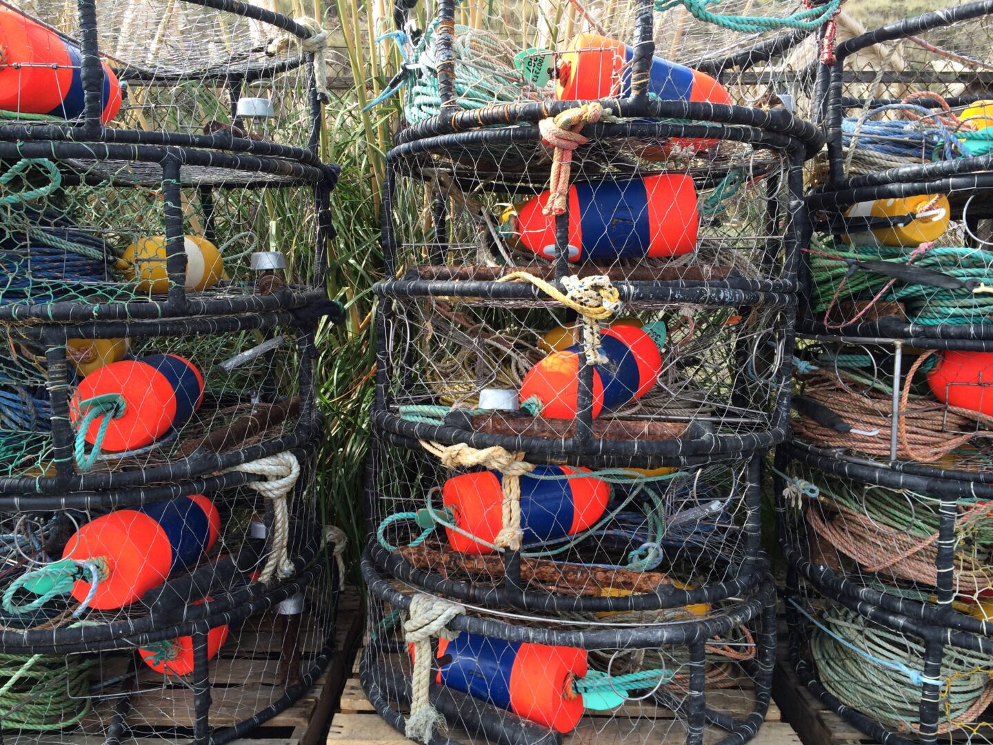 A bunch of lobster traps stacked on top of each other.