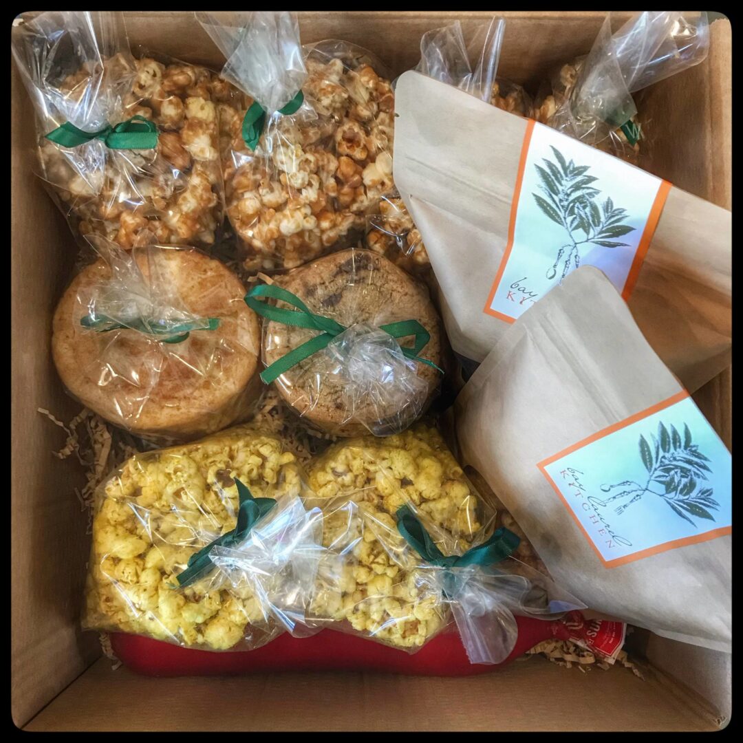 A box filled with popcorn and other snacks.