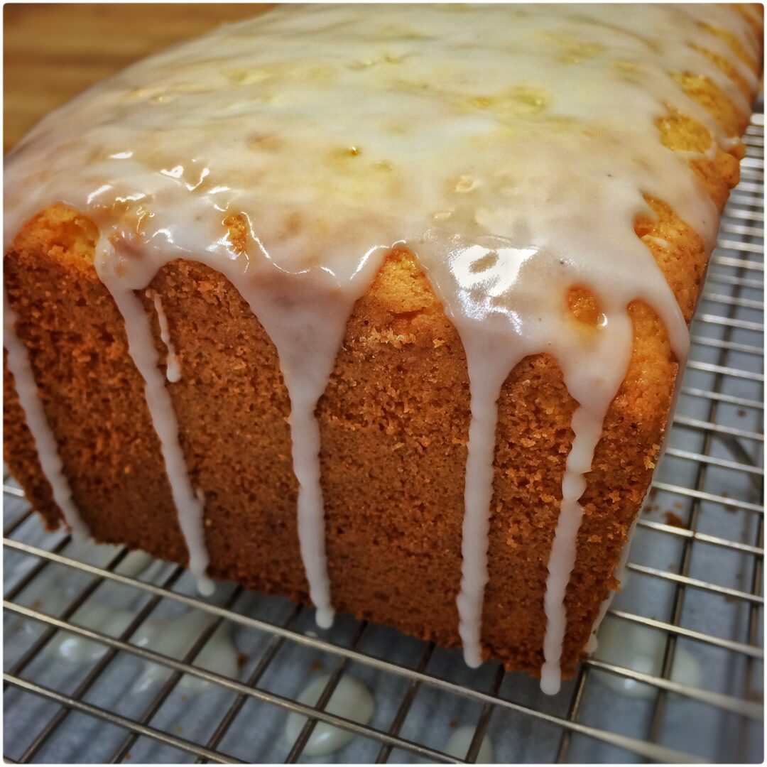 A loaf of lemon pound cake with icing.