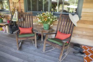 Wooden rocking chairs on a porch.