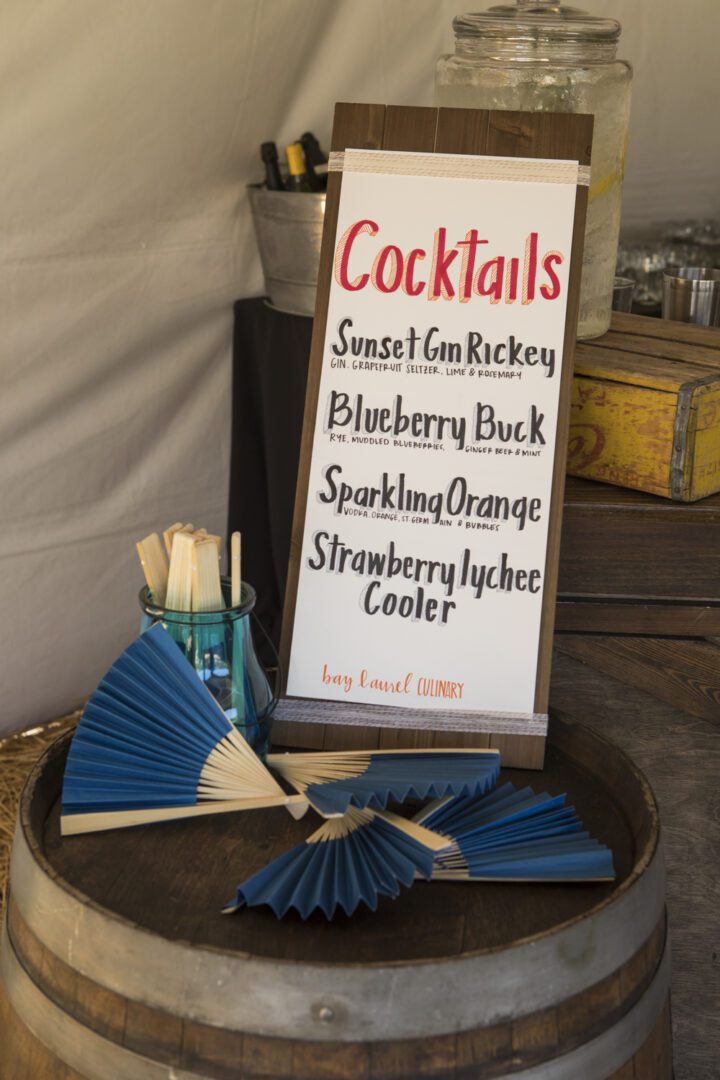 A sign for cocktails on a barrel.
