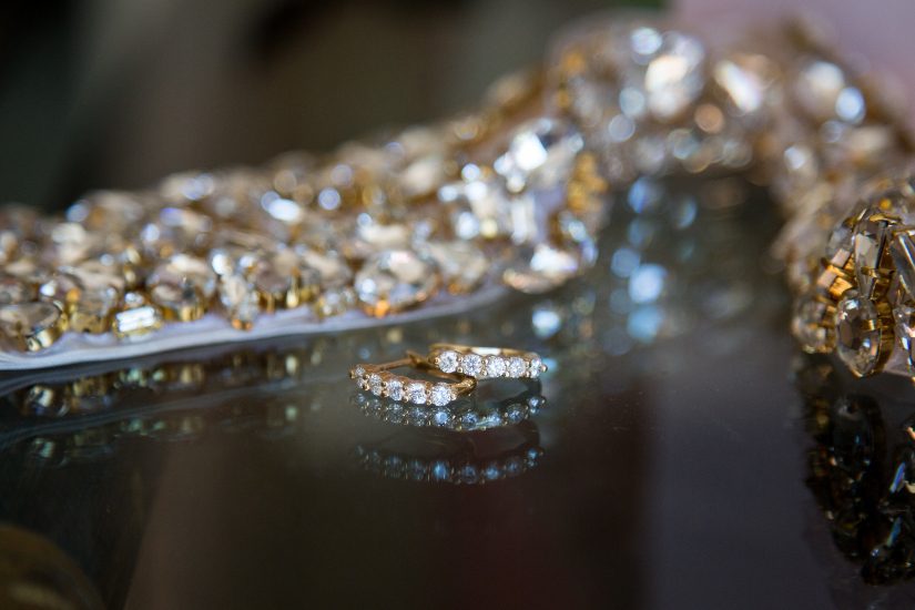 A gold ring is sitting on top of a glass table.