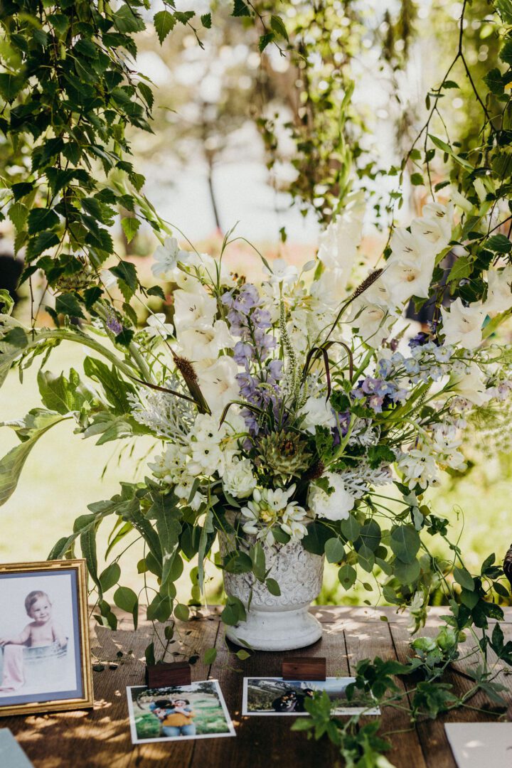 A table with flowers and pictures on it.