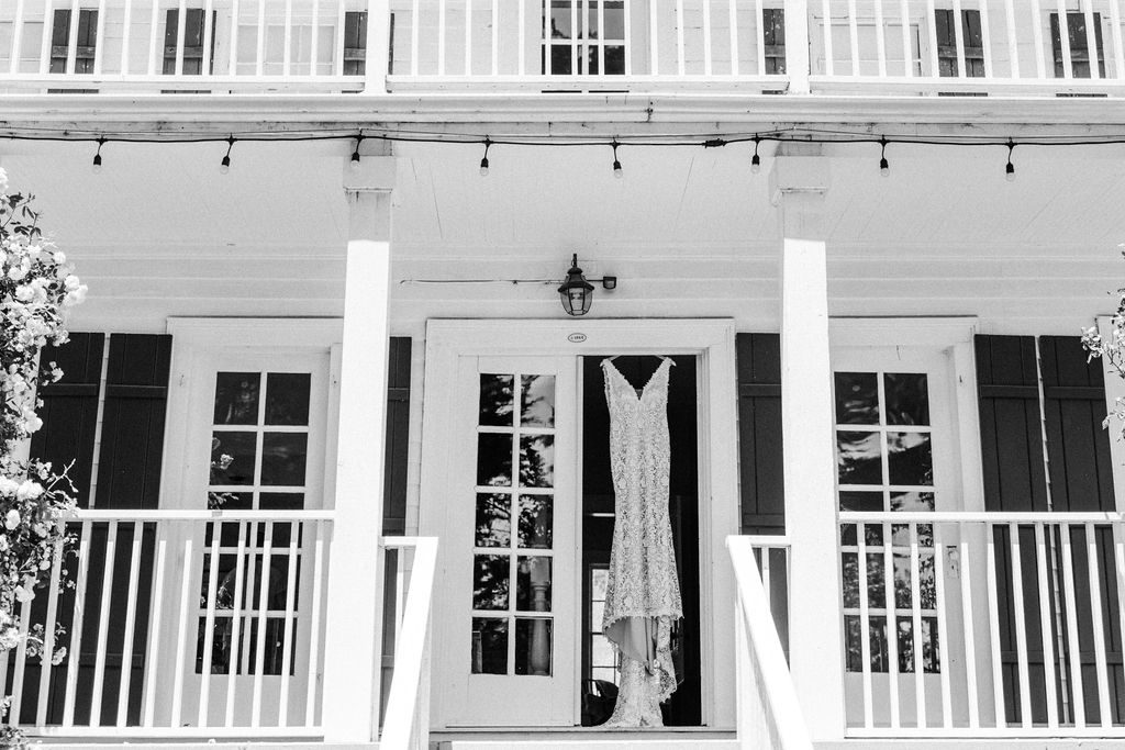 A black and white photo of a front porch.