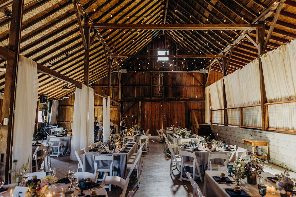 A wedding reception set up in a barn.