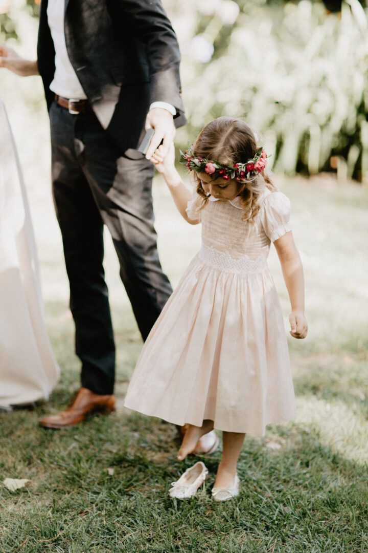 A man and a little girl walking down the aisle.