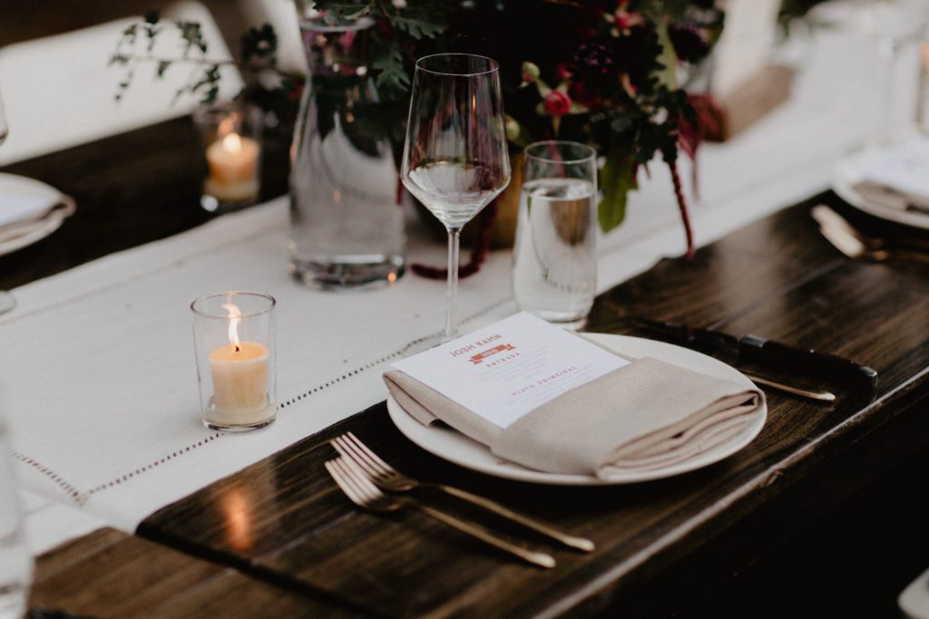 A table setting with a candle and place settings.
