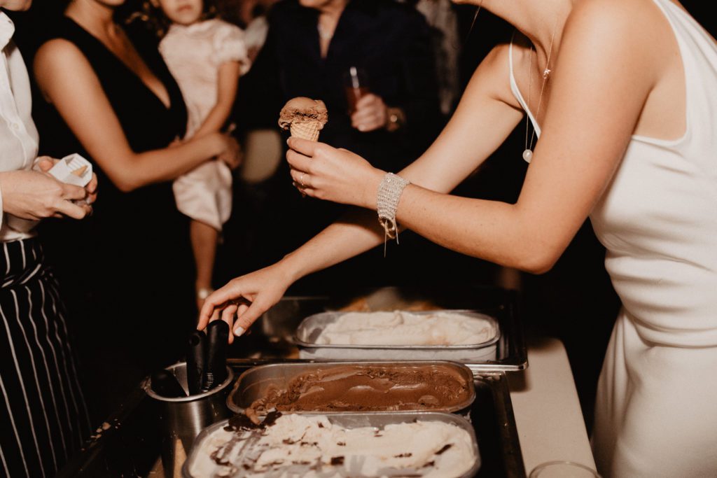 A woman serving ice cream at a party.