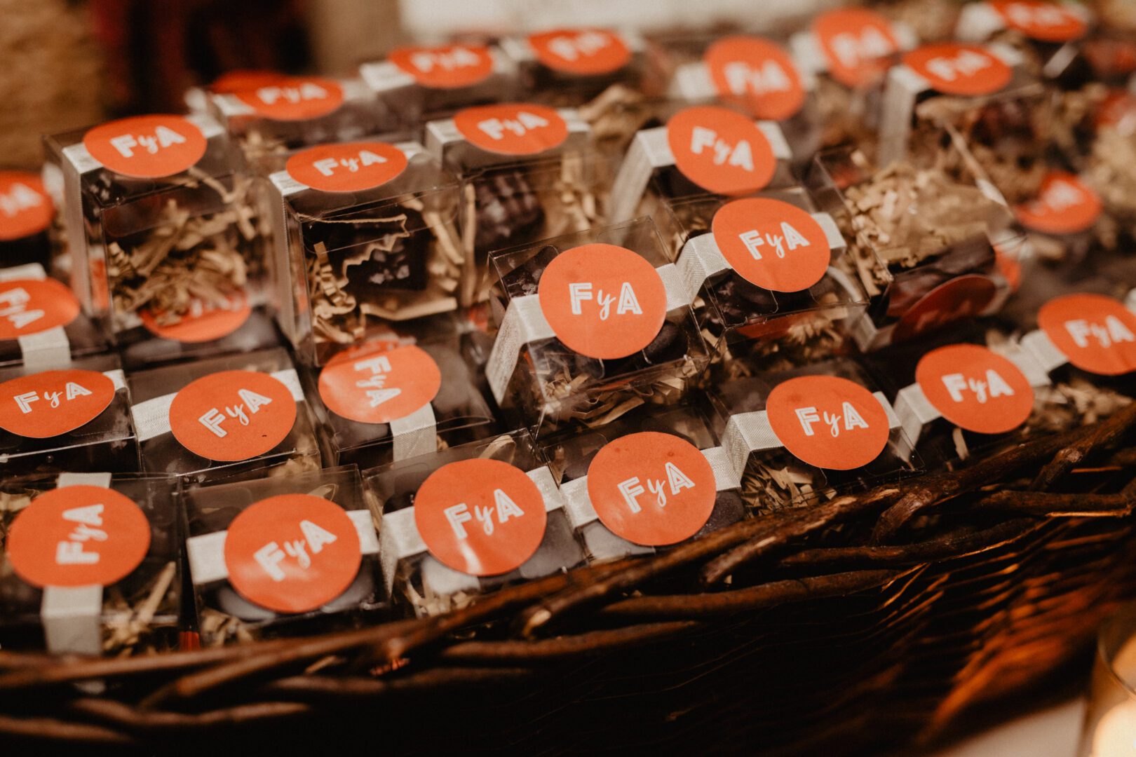 A wicker basket full of chocolates with labels on them.