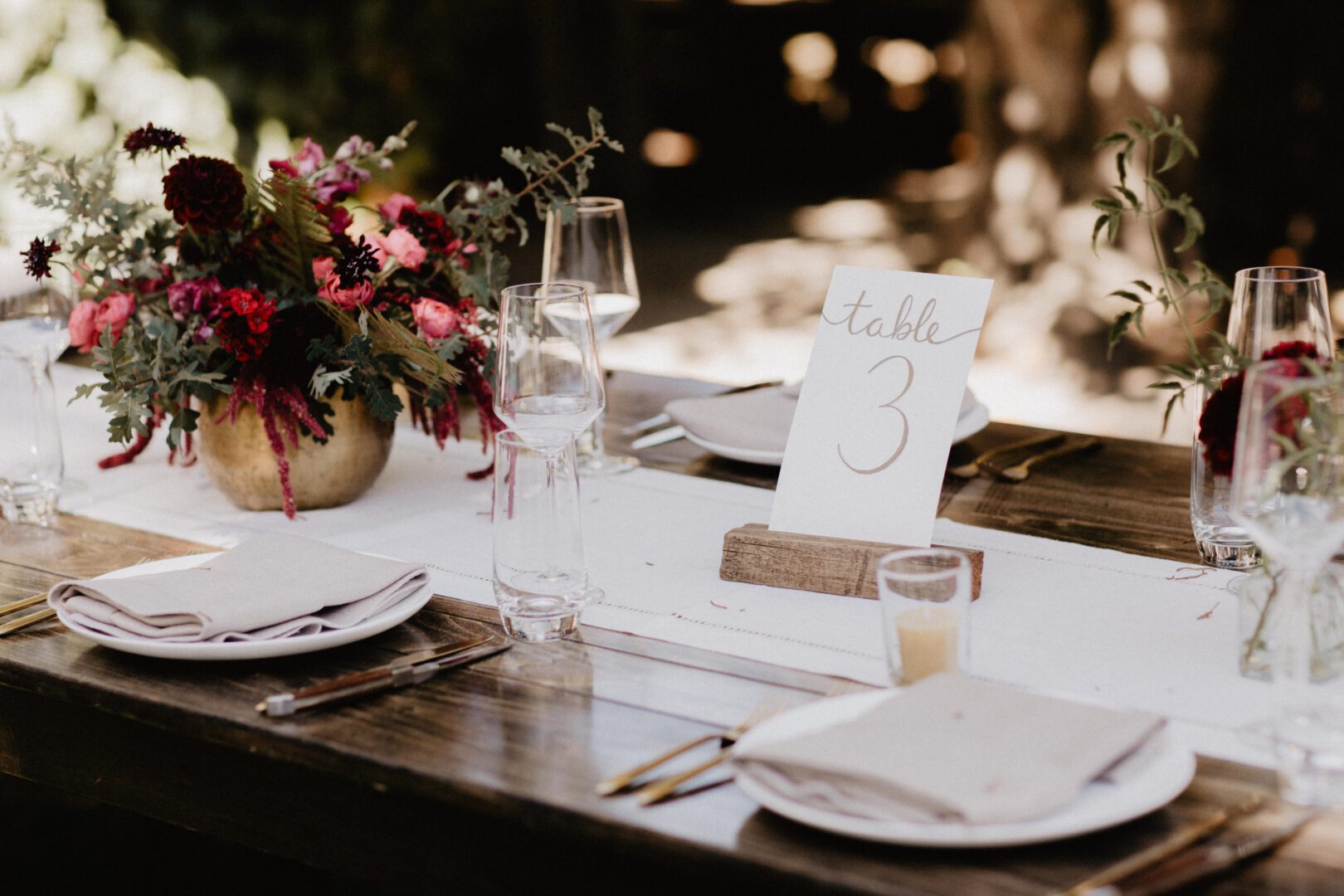 A table setting with a number and flowers.