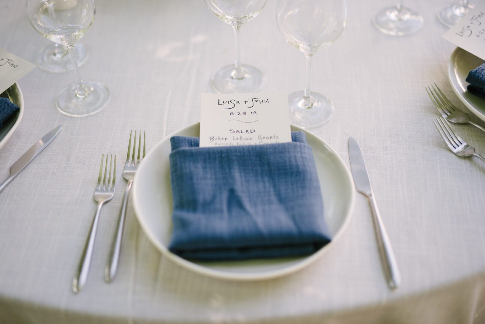 A table setting with a blue napkin and silverware.